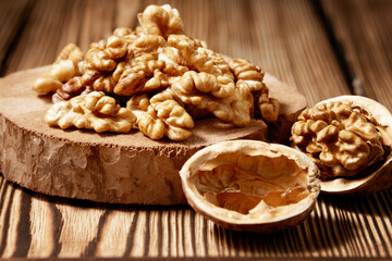 Close-up of peeled walnut kernels on a wooden board.