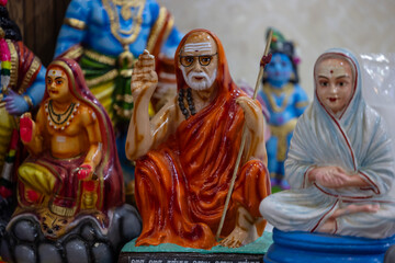 Handmade Indian guru Adi Shankaracharya sculpture souvenir made with fiber with plain background. Selective focus. - obrazy, fototapety, plakaty