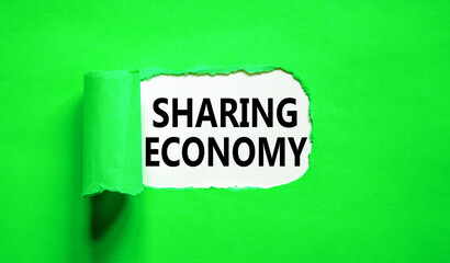 Sharing economy symbol. Concept words Sharing economy on beautiful white paper. Beautiful green paper background. Business sharing economy concept. Copy space.