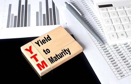 Word YTM Yield To Maturity made with wood building blocks, business concept
