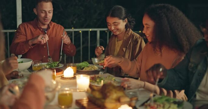 Friends, food and eating at night for dinner and party with celebration and happiness. Social event, men and women have meal together with diversity, hungry for cuisine and friendship outdoor