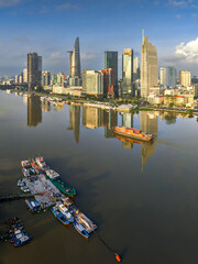 Aerial photo of downtown Ho Chi Minh City, Vietnam's largest city with high-rise buildings next to the riverbank.