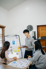 Close up view of UI developer team brainstorming on their project with laptop, smartphone and...