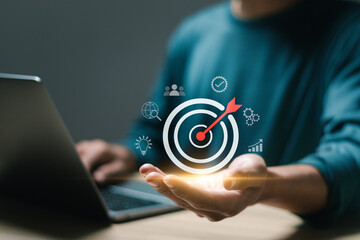 Businessman use laptop with target icons for business objective. Strategic planning for business growth and target customer group. set up business objective target goal. Targeting business concept.