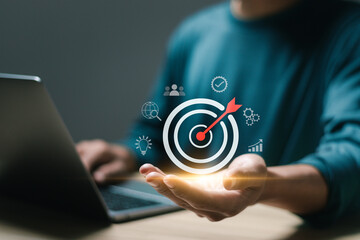 Businessman use laptop with target icons for business objective. Strategic planning for business...