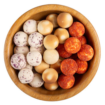 Various varieties of kurt cheese. Kurt -  traditional Central Asian cheese. Small hard white cheese balls in wooden bowl isolated on white. Salty dairy snacks. Top view.