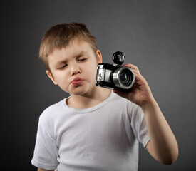 Little boy with old camera