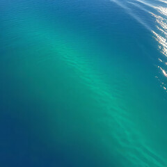 Obraz premium Ocean surface on an island in California with gentle ripples on the surface and refraction of light, clear water, stones at the bottom of the sea, clean environment concept,