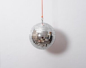 Discoball on a background of white wall. Copy space.