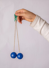 photo of clackers balls hanging by the hand 