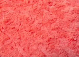 Pink wool fabric. Pink-red carpet texture, close up. Background with swirl material texture red, salmon hairy curly fabric.