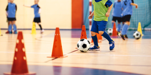 Children in Futsal Training. Indoor Soccer Class for Kids at School Sports Hall. Children Kicking Soccer Balls on Wooden Futsal Floor