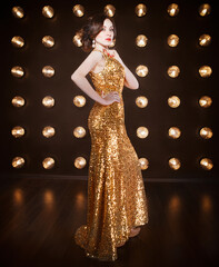 Superstar woman wearing golden shining dress