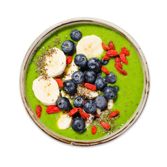 Healthy Green Smoothie in a Bowl with Banana, Blueberry, Goji, and Chia Seed Toppings on White Background