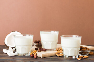 Set or collection of various vegan milk almond, coconut, cashew, on table background. Vegan plant based milk and ingredients, top view