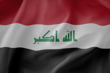 Naklejka premium Iraq waving flag close up fabric texture background