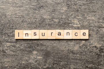insurance word written on wood block. insurance text on table, concept