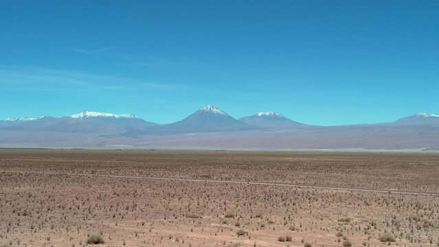 Beautiful aerial footage of the a person walking alone in the Atacama Dessert - Calama - Antofagasta Dessert and Salar - turquoise lagoon.