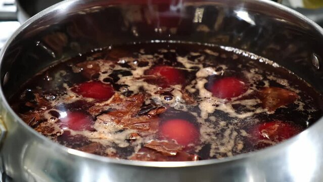 The eggs boiled in pot with onion peels for coloring. Preparation for Ester celebration. Traditional eco dye. Food cooking. High quality 4k footage