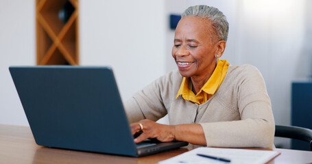 Fototapeta na wymiar Happy senior woman, laptop and typing in finance with documents for bills or expenses in remote work at home. Mature African female person or freelancer smile on computer in financial budget at house