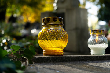 Cemetery grave candle glass lantern. Memorial light remembrance snitch or znicz. All Saints' Day, Feast of All Souls. Commemoration of All the Faithful Departed and the Day of the Dead.