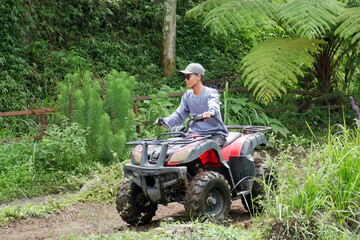 Asian man playing ATV Ride Adventure Tour in Malang, Indonesia
