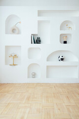 Modern bright interior of living room with white wall and niches