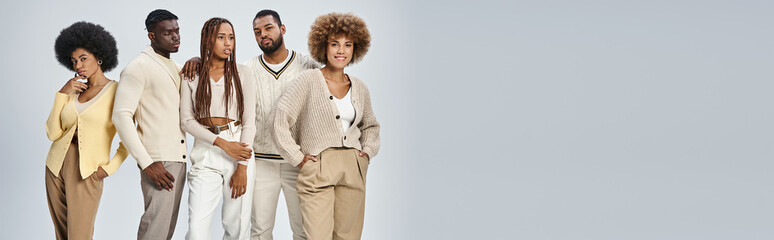 stylish african american people in casual attire standing on grey background, Juneteenth concept