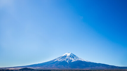 Panorama of Mount Fuji with blue sky in the foreground in autumn in Kawaguchiko, Yamanashi, Japan....