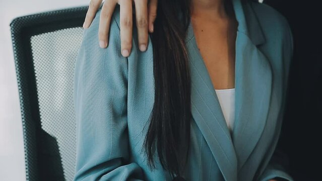 Beautiful young woman being victim of sexual harassment at workplace, copy space. Male boss touching his female secretary without permission at office. Corporate discrimination concept