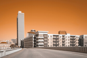 Fort Worth City skyline and buildings road trip photo in orange color monotone over the highway in...