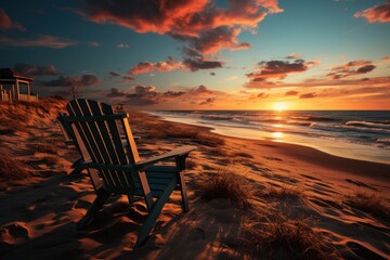  a wooden chair sitting on top of a sandy beach next to the ocean as the sun sets over the ocean and a life guard tower in the distance in the distance. - obrazy, fototapety, plakaty