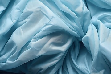  a close up of a blue cloth with a very large amount of wrinky fabric on top of the fabric and bottom of the fabric is slightly wrinkled fabric.