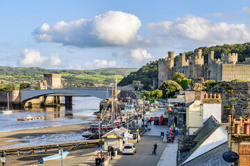 Conwy, North Wales - The waterfront, castle and two bridges on a fine autumn afternoon. - obrazy, fototapety, plakaty