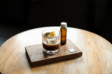 A glass of iced espresso with lemon and bottle