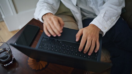 Man fingers working computer at home closeup. Busy guy hands texting laptop