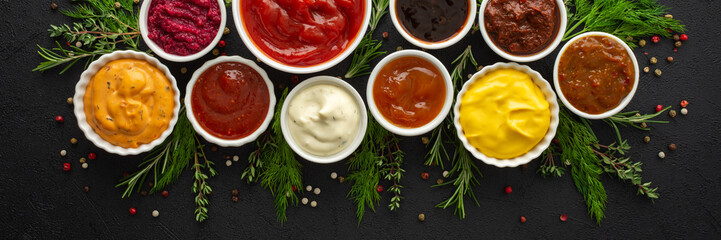 Different types of sauces in bowls with seasonings banner, rosemary and dill, thyme and and...