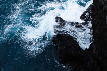 Waves crashing on volcanic rocks on Madeira