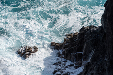 Waves crashing on volcanic rocks on Madeira