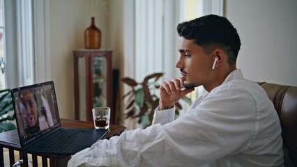 Gesturing man talking laptop video call at home close up. Guy speaking online