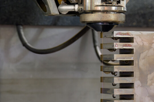Closeup scene the wire EDM machine cutting the mold insert parts.