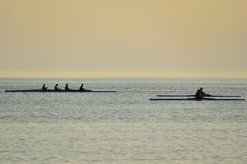 Naklejka premium rowing (skiff) at sunset - Paralia Richa Nera (beach), Myrina, Lemnos island, Greece, Aegean sea