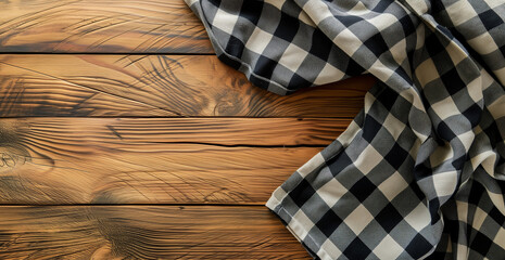 Top view of black checkered tablecloth on blank empty wooden table background banner, food concept