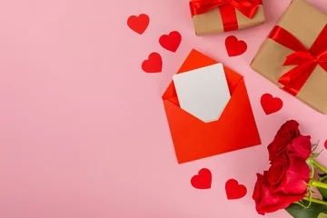 Fotobehang Valentine's Day concept.Valentine's Day background. Gifts, candles, confetti, envelope - postcard, candy, glasses, wine and a bouquet of roses on a colored background. Flatley.Valentine's day celebrat © Avocado_studio