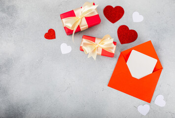 Valentine's Day concept. Valentine's Day background. Gifts, candles, confetti, envelope - postcard on a marble background. Flatley, top view, copy space.Valentine's day celebration