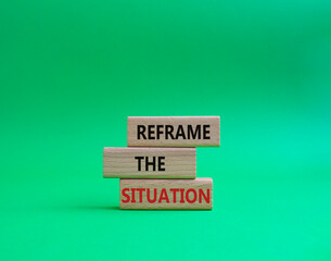 Reframe the situation symbol. Concept words Reframe the situation on wooden blocks. Beautiful green background. Business concept. Copy space.