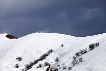 Off piste slope and overcast sky in windy day - 705767796