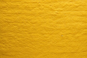  a close up of a yellow wall with a black and white cat on it's side and a black and white cat on the other side of the wall.
