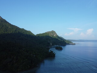 Fototapeta na wymiar Tranquil Scene of a Beautiful Bay with Blue Water and a Scenic Landscape in sawai saleman, maluku, indonesia