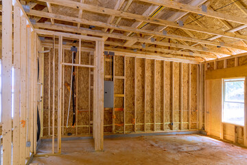 Construction of new home with wooden framing beams